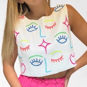 NWOT. QUEEN OF SPARKLES White and Multicolor Face Pattern Crop Top